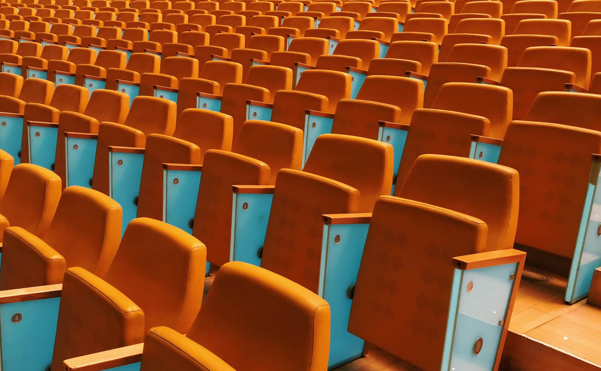 Orange stadium seats with multiple rows and columns.