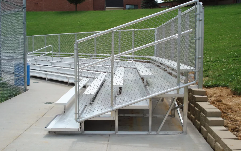Outdoor non-elevated bleachers with angled seating.